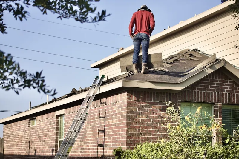 Professional roofer working on a residential roof in Coyote Lakes